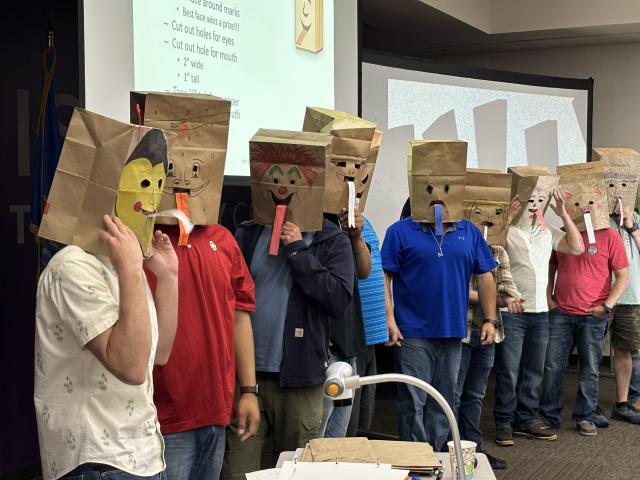 Students at PET Module 5 Gas Measurement are demonstrating Bernoulli's Principal. By blowing out of the mask, the tongues on the mask stick out.