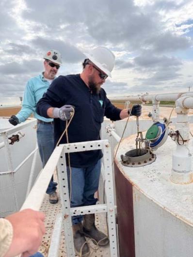 Students at PET Module 4 Oil Measurement gauge an oil storage tank to determine the quantity and quality of the oil in the tank.