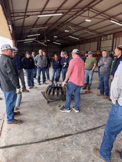 Students visit a Blowout Preventer Equipment Supplier during PET Module 2 Drilling. The students are learning about the internal component of an annular preventer which is used to close in the wellbore during drilling.