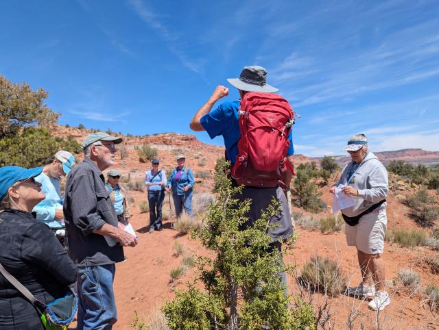A man guides hikers on a botany hike