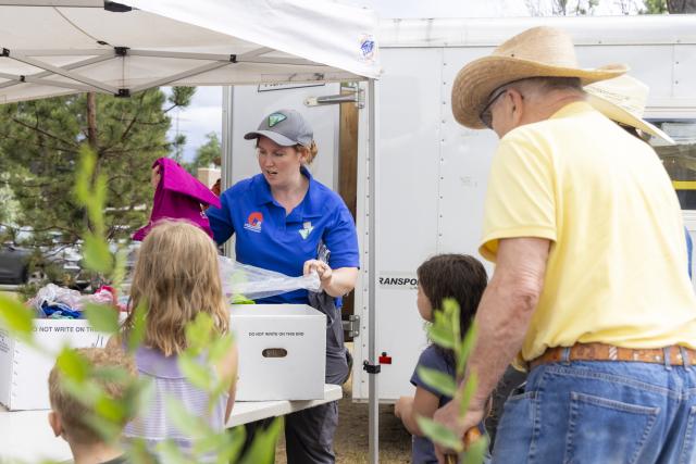 Bureau of Land Management employees assist visitors and qualified adopters during the annual wild horse adoption event at Lions Park