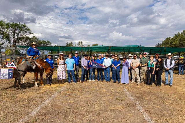 Secretary of the Interior Doug Burgum, Bureau of Land Management Wyoming employees, partners and other dignitaries pose for a group photo during the annual wild horse and burro adoption event at Lions Park in Cheyenne