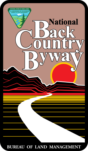 Back Country Byways Logo. A graphic of a mountains and a road leading toward a red setting sun.