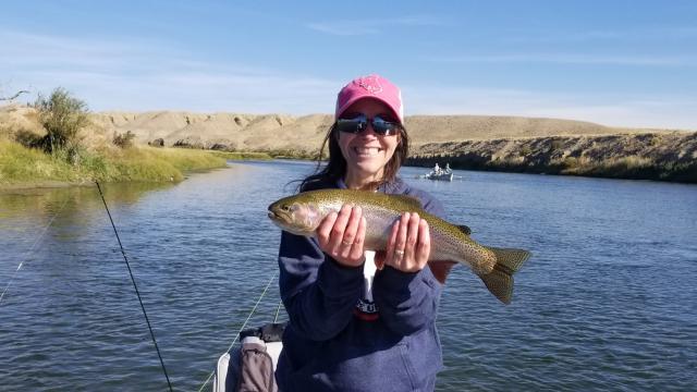 A visitor holds a trout caught in the Green River on the Seedskadee National Wildlife Refuge in southwestern Wyoming.