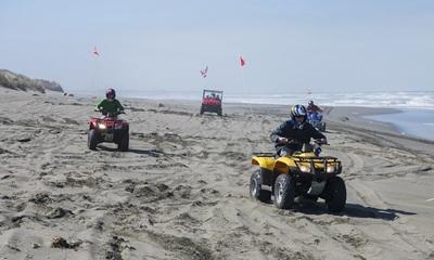 Off Highway Vehicles on a ocean beach.