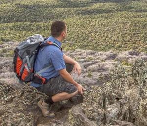 Close-up of hiker with backpack looking into the distance