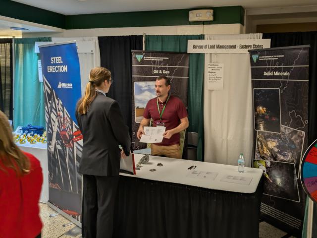 Career fair booth for the Bureau of Land Management, featuring oil and gas and solid minerals displays.