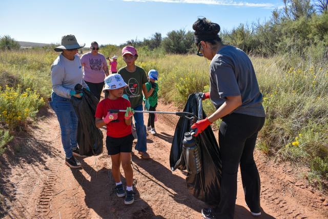 Members of Girl Scouts Troop 18044 and their parents pick up trash during a National Public Lands Day cleanup event at the Bureau of Land Management Roswell Field Office’s Oxbow Day Use Area on Sept. 12.