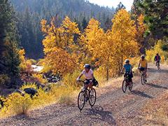 A family rides bikes on a dirt trail overlooking the Susan River.  Photo by Bob Wick, BLM.