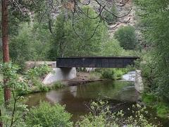 A rail bridge over a forest creek.  Photo by Jeff Fontana/BLM