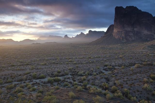 Sun peaks through clouds above the Eagletail Mountains Wilderness in Arizona.