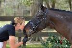 Woman kissing horse. 