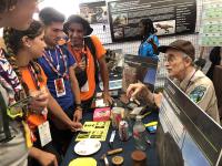 Bob King talking to scouts at the Department of Interior booth at the Scouts Jamboree