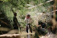 Crewmembers use stadia rod and auto level to measure slope of the stream reach. 