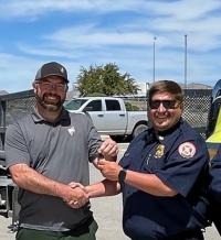 Elko District AFMO Craig Cunningham hands over the keys to Elko County FPD Fire Chief Matt Petersen