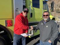 Chad LaVallee, Fire Chief with Alfalfa Fire District shakes hands with Prineville District Deputy Fire and Aviation Staff Officer Nathan Lefevre after receiving the keys for the wildland fire engine