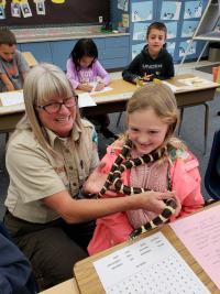 Ranger Tammy and Kolbie the California Kingsnake visit all the classes participating in the program. Students learn why we don't take animals from the wild, not to release pets into the wild, and that we don't have to kill animals that we are afraid of. 