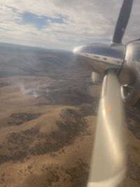 An aircraft flies near Hidden Fire