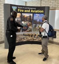 Attendee speaks with representative about BLM Fire program.