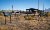 A sign reading Litchfield corral and a large  covered  structure with hay underneath.