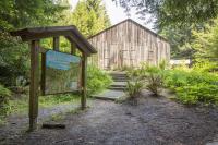 An old building and signage in a forest.