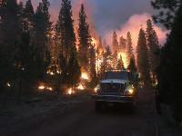 Fire engine passes through the wildfire flames
