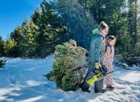 A mother and daughter harvest a christmas tree from public lands. 