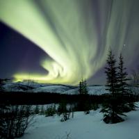 Northern lights over a snowy mountain