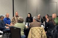 BLM staff and local recreation partners discuss recreation in the Grand Junction area around a table at the Grand Junction Convention Center Jan. 13