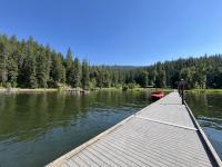 Photo shows Mica Bay Boater Park from the perspective of the dock/water. 