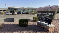 a view of an office building with a sign that reads Phoenix District Office, Hassayampa Field Office, Lower Sonoran Field Office, U.S. Department of the Interior, Bureau of Land Management