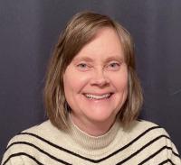 Headshot of Ruth Miller smiling for the camera.