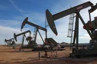 Four oil derricks pumping oil in at DASLM in North Dakota