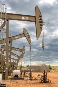 Photo of oil and gas drilling equipment under a cloudy sky