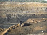 Bulldozer at edge of Dry Valley Mine gorge.  Gorge is striated in color. 