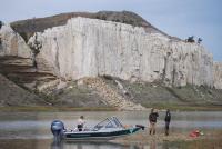 Two rangers use a boat to patrol the White Cliffs section of the Upper Missouri River Breaks National Monument.