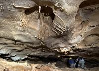 Two people explore a cave