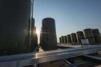 The sun shines through storage tanks at an oil pipeline system in New Mexico.