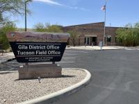 Gila District and Tucson Field office sign in front of an office building with an American flag