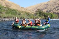 A group of youth raft on the river.