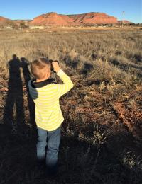 Child birdwatching with binoculars