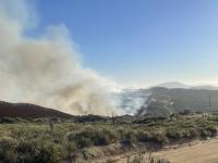 Border 6 Fire. (Photo by Robert Hermes) smoke in the air and a blue sky