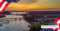 Aerial view of the Loxahatchee River at sunset, featuring American flags, boats, and text celebrating 250 years on February 17, 2026.