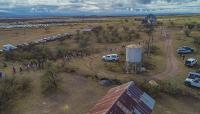 Runners navigate the race course that passes by Empire Ranch structures like a windmill