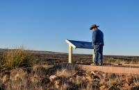 A visitor to the Valley of Fires Recreation Area reads a new interpretive sign at the start of the Malpais Nature Trail on Jan. 16.