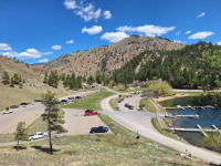 landscape photo of parking lot next to lake 