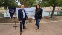 Deputy Secretary of the U.S. Department of the Interior Kate MacGregor and Deputy BLM Director Bill Groffy stand in front of a giant check.
