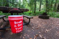 red water bucket in a campsite.