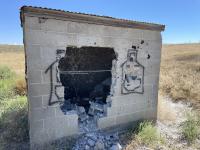 Image of vandalized cement pumphouse