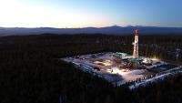 Geothermal rig with mountain range in the background